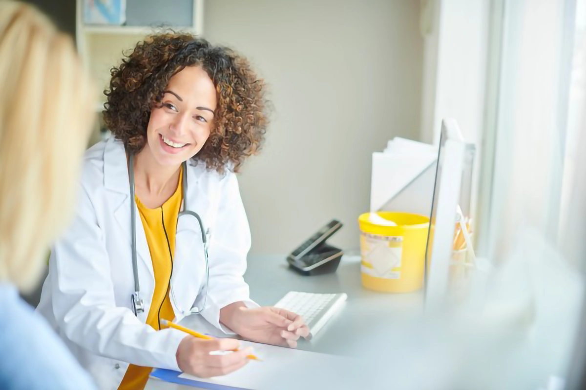 Image of a doctor talking with a patient within a surgery